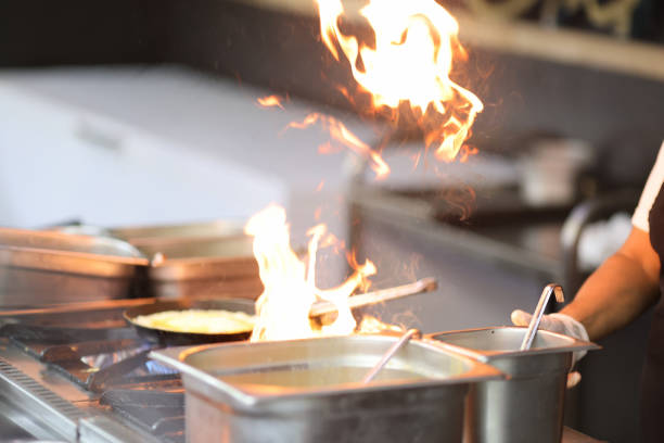 istock Cook is cooking on stove with an open fire 1298951915