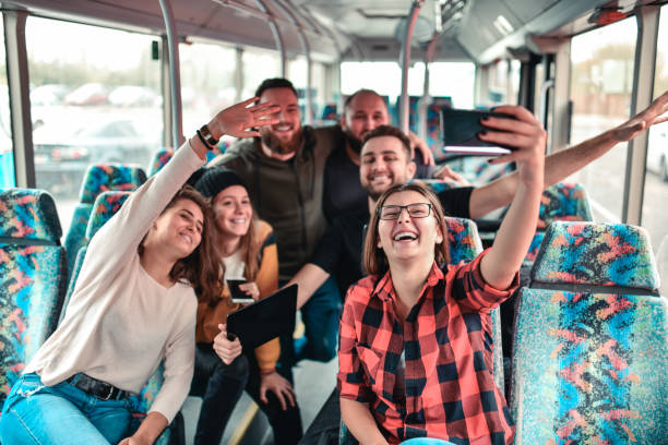 istock Smiling Selfie Time For Happy Friends During Bus Ride 1298952014