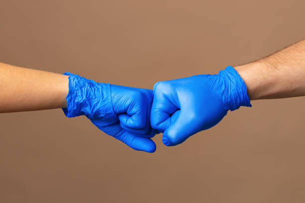 istock Handshake in a blue gloves, help concept. Personal hygiene during a pandemic 1298952035