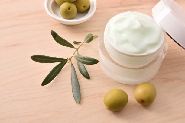 istock Moisturizing cosmetic cream with olive extract for skin elevated view 1298952816