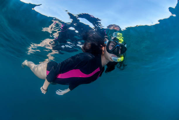 istock Young woman snorkelling 1298953755