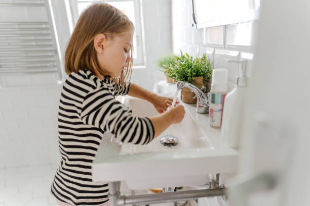 istock Little girl's washing hands 1298954060