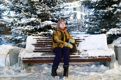 Woman on snowy bench at night, Kazan