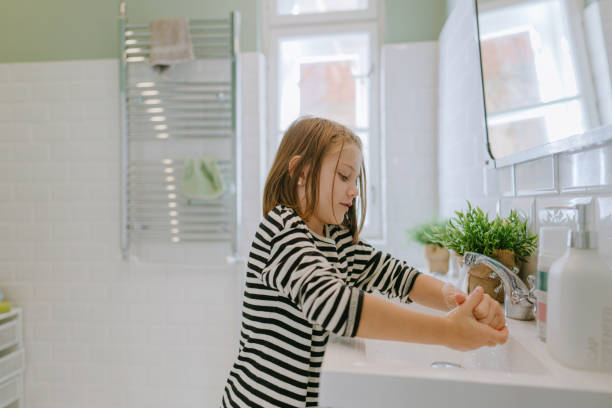 istock Little girl's washing hands 1298954176