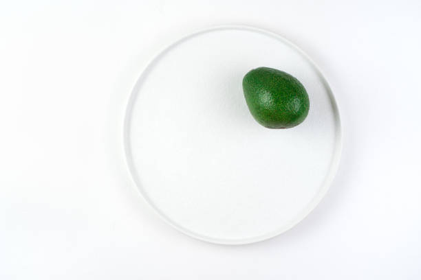 Flat plate with avocado on a light background