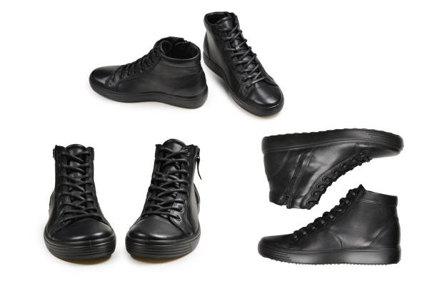 istock Men's black leather shoes and a black camera on a isolated on white background. Copy space. 1298956685