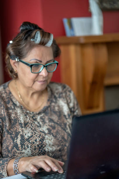istock Mature Hispanic woman wearing hair rollers 1298957485