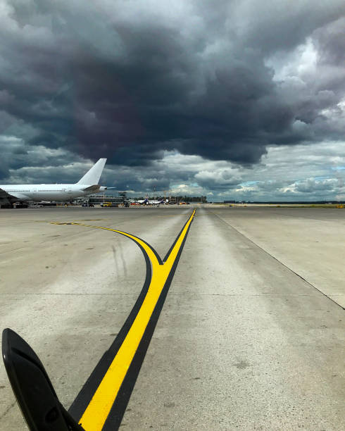 istock Gloomy sky with dark clouds over the airport 1298958877