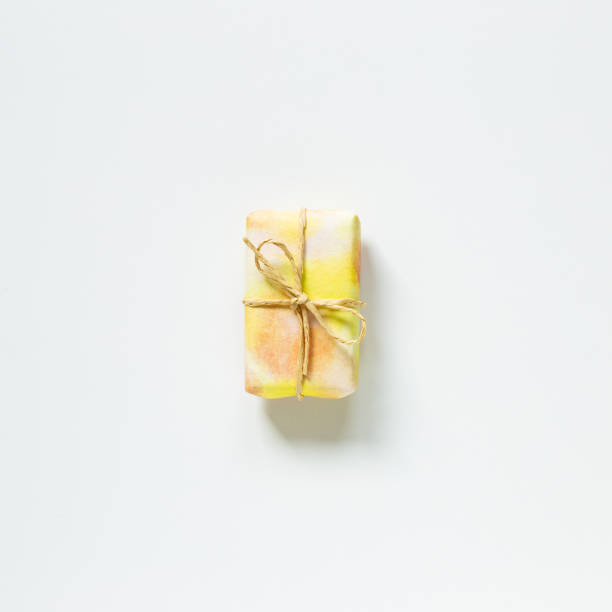 istock Yellow gift box isolated on white background. top view, copy space 1298959083