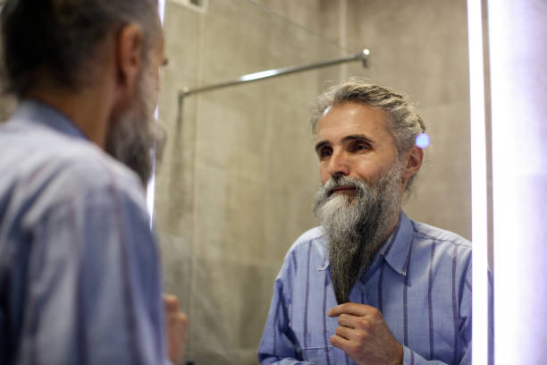 istock Senior man taking care of his beard 1298960593