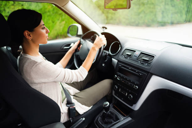 istock High angle view of a woman driving 1298961360