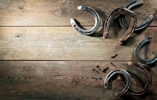 Old rusty horse shoes on barn floor
