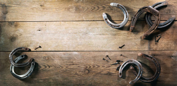 istock Old rusty horse shoes on barn floor 1298961408