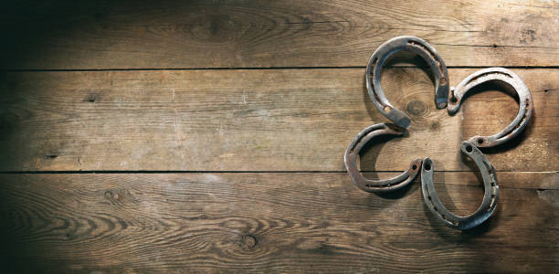 istock Four leaf clover made out of old rusty horse shoes 1298961424