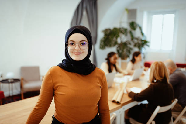 istock Young Middle Eastern woman working in office after reopening, looking at camera 1298961470