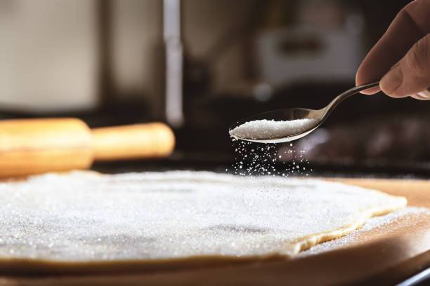istock hand sprinkles sugar dough on the table 1298963170