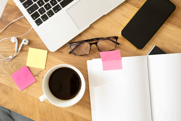 istock Work table in the office or at home with computer, mobile, notebook, glasses and pen 1298964641