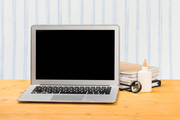 istock mocap Notebook with notebooks and stationery on a wooden table. 1298964857