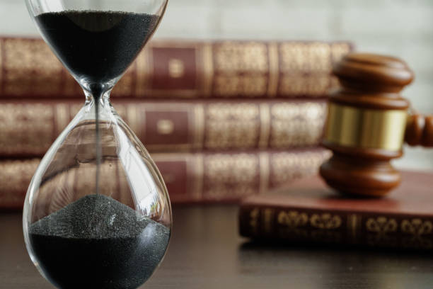 istock Court concept. Hourglass and judge gavel on table 1298965016