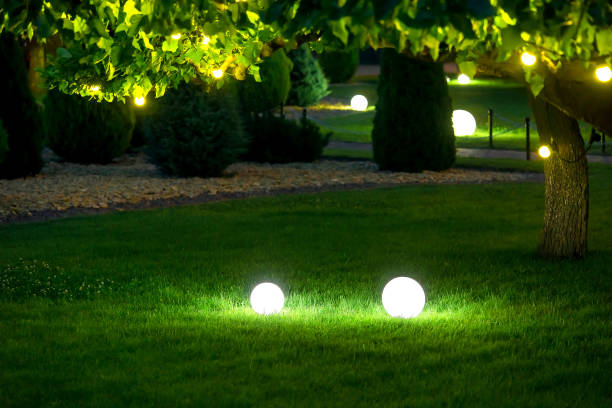 istock illumination garden light with electric ground lantern with ball diffuser lamp on meadow with garland of warm light bulbs on tree branch with leaves with landscaping, illuminate evening scene nobody. 1298970908