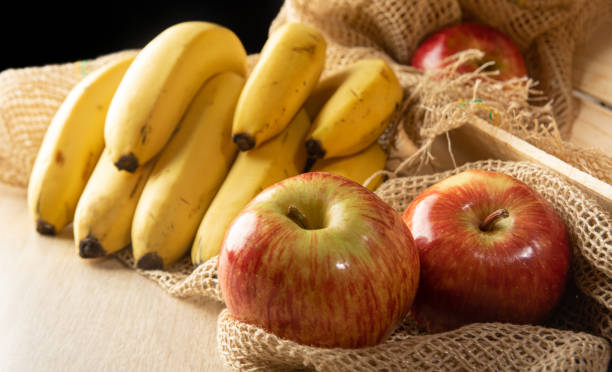 Fresh fruits, apples, oranges and bananas on display for hungry customers.