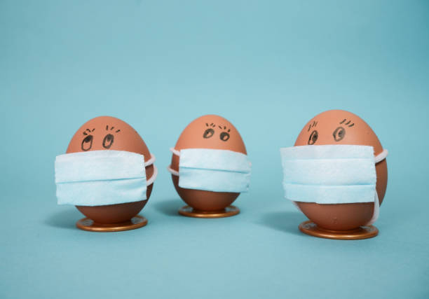 istock Easter chicken eggs in medical masks. Easter 2021 concept due to quarantine 1298971798