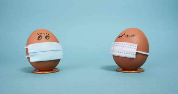 istock Easter eggs with COVID19 corona virus protection concepts. Easter eggs in a mask to decorate the Easter holidays. On a blue background with copyspace. 1298972419