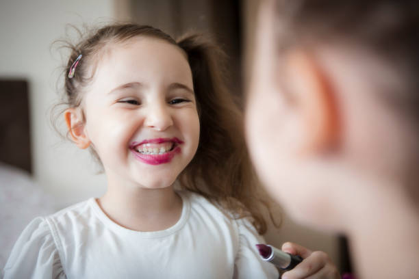 istock Little girl's first lipstick 1298973170
