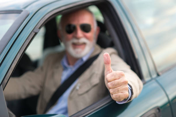 istock Senior man driving car 1298973896