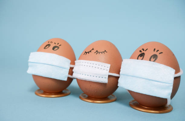 istock Easter chicken eggs in medical masks. Easter 2021 concept due to quarantine 1298974243