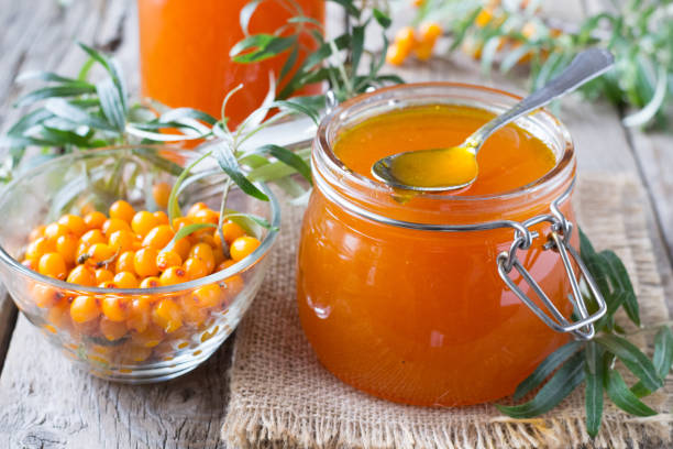 istock Sea buckthorn jam in jar on wooden table 1298974366