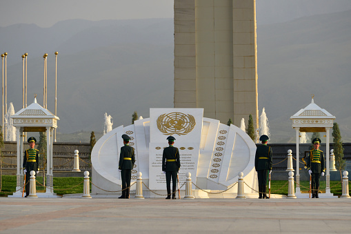 Ashgabat, Turkmenistan: fresh soldiers arrive - change of the ceremonial guard at the Arch of Neutrality, Neutrality Avenue - Guard mounting - UN logo over white marble - Neutrality was enshrined in Turkmen legislation and by the UN with the adoption of the UN General Assembly resolution on Permanent Neutrality of Turkmenistan - soldiers carriying SKS Soviet semi-automatic carbines (gas-operated rifle) - Bitaraplyk arkasy / Bitaraplyk binasy.