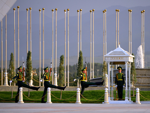 Ashgabat, Turkmenistan: goose stepping soldiers, change of the ceremonial guard at the Monument of Neutrality aka Arch of Neutrality, Neutrality Avenue - the Neutrality was enshrined in national legislation and by the UN with the adoption of the UN General Assembly resolution on Permanent Neutrality of Turkmenistan - soldiers carriying SKS Soviet semi-automatic carbines (gas-operated rifle) - Guard mounting - Bitaraplyk arkasy / Bitaraplyk binasy.