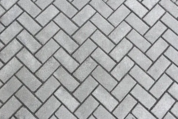 Photo of Sidewalk gray tiles diagonally. Texture, pattern. Copy space