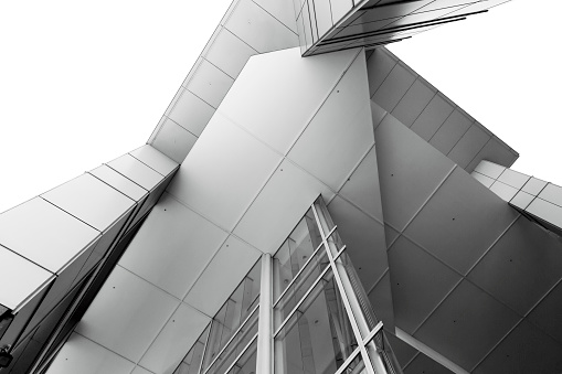 Black and white low angle view of modern office building, abstract background with copy space, full frame horizontal composition