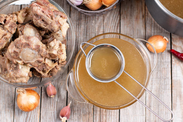 istock Passing the bone broth through a sieve. Concentrated Bone Broth in a bowl on the table 1298979932