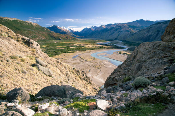 istock Beautiful green valley with winding river 1298980167