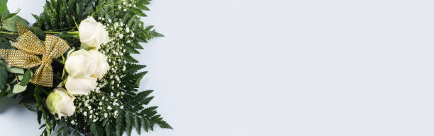 istock White roses bouquet as gift on a holiday on gray 1298982529