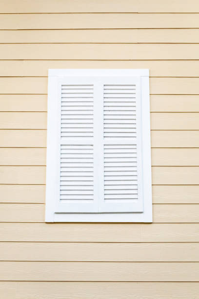 istock White Louvered Window Shutter on a Cream Wooden Building 1298983051