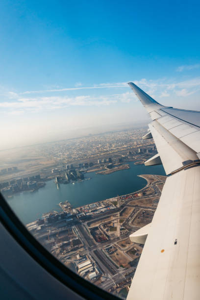 View through airplane in air View through airplane in air on clouds and New Delhi above. wow airlines stock pictures, royalty-free photos & images