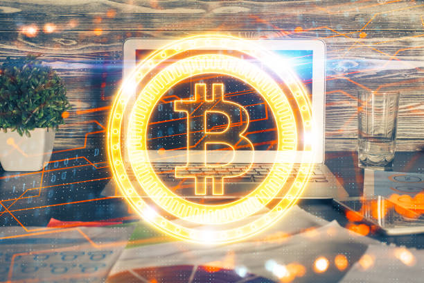 istock Multi exposure of blockchain theme hologram and table with computer background. Concept of bitcoin crypto currency. 1298984124