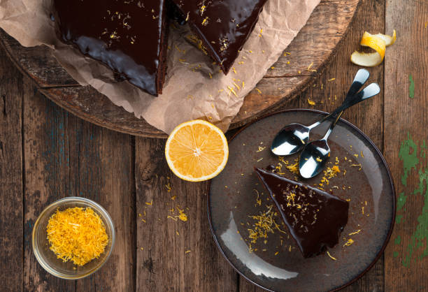 istock Chocolate cake with icing and lemon zest on a wooden background 1298985494