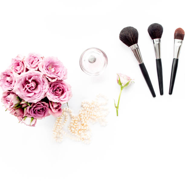 istock Makeup tools. Home office workspace. Female fashion, makeup brushes, cup of coffee on white background. Flat composition. Top view. Flat lay 1298986000