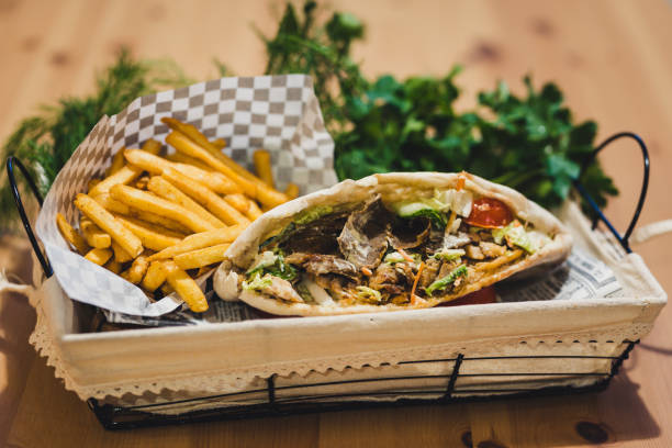 istock Open Beef Kebab with fries and some greens in Basket, Copy Space on Top - Selective Focus 1298986749