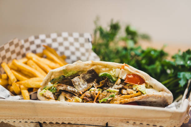 istock Open Beef Kebab with fries and some greens in Basket, Copy Space on Top - Selective Focus 1298986750