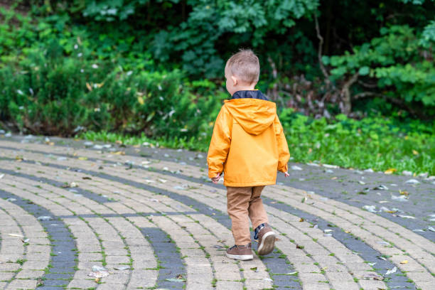 istock Kid Running on Pavement in Park, Enjoying Free Time Outside 1298988154