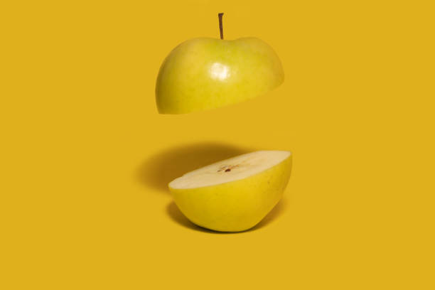 apple green sliced jigsaw covered in water droplets