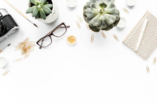 istock desk workspace with succulent, coffee, diary, glasses and golden clips on white background. flat lay, top view 1298989217