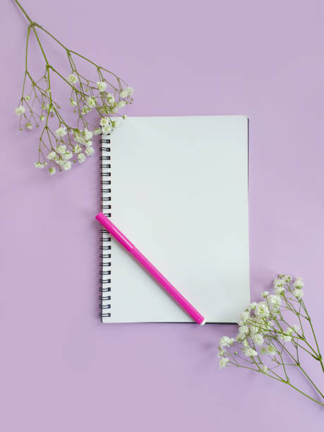 istock notebook  gypsophila flowers on a colored background 1298989327