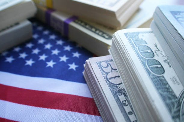 american dream of financial abundance concept with stacks of money on the united states flag high quality - pension investment retirement wall street fotografías e imágenes de stock